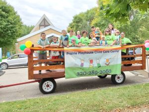 A picture of children on a wagon at Prairie Playhouse Childcare Center